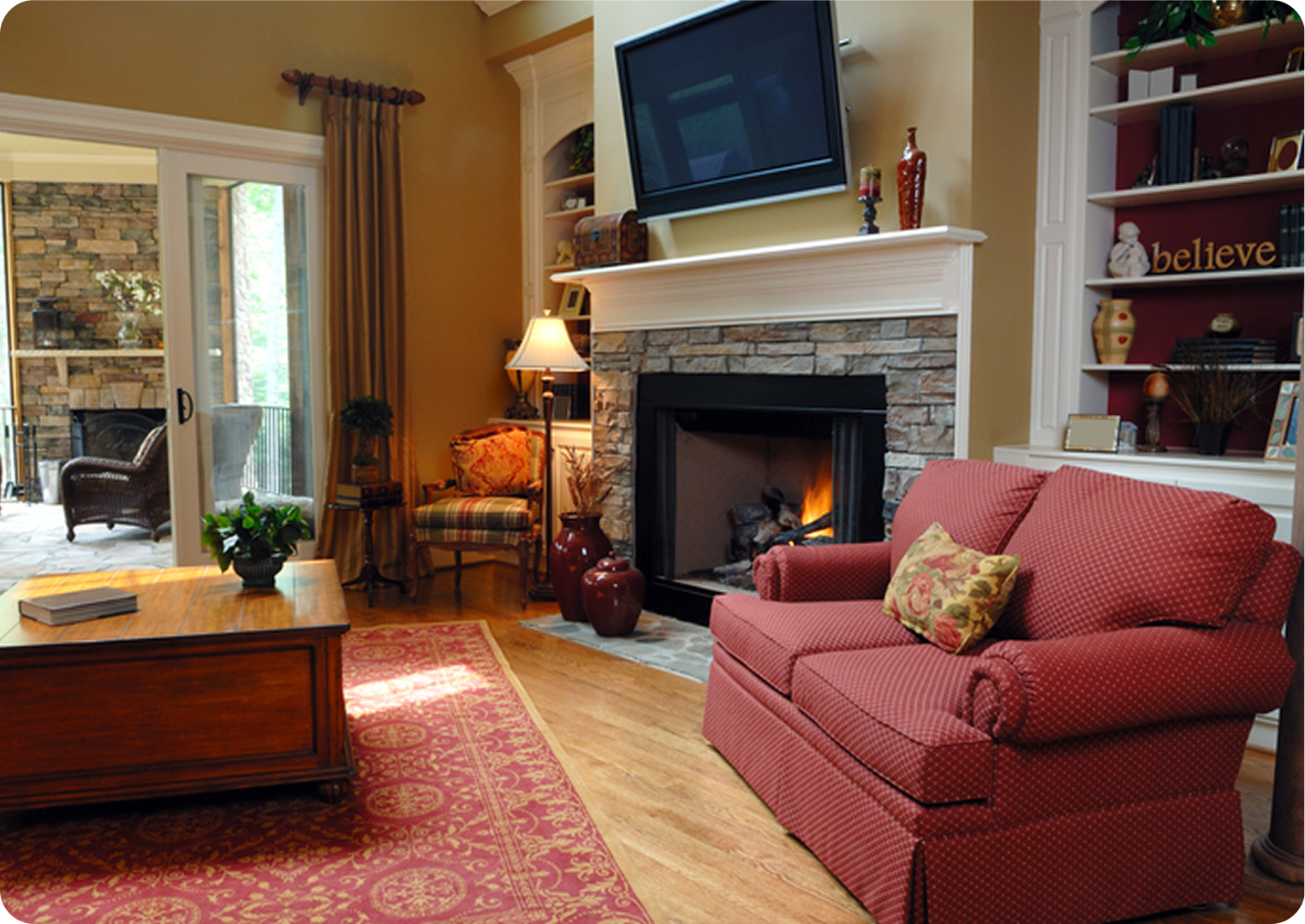 Cozy living room with fireplace and armchair.