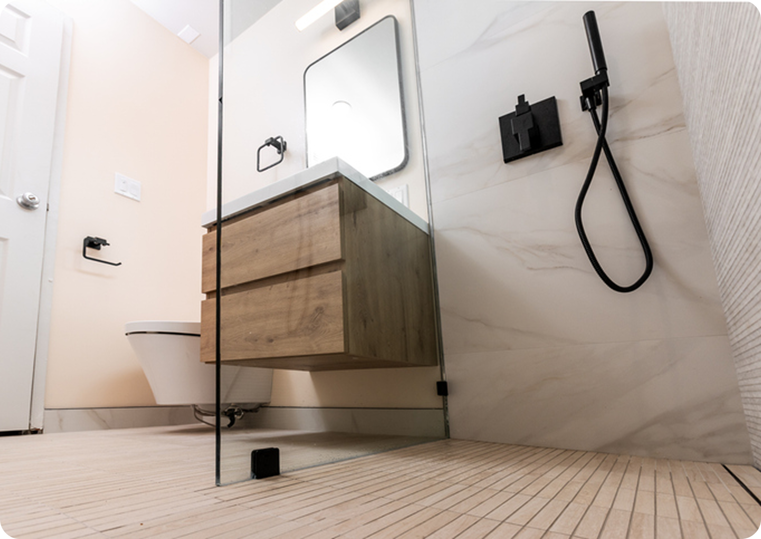 Modern bathroom with wooden vanity and shower.