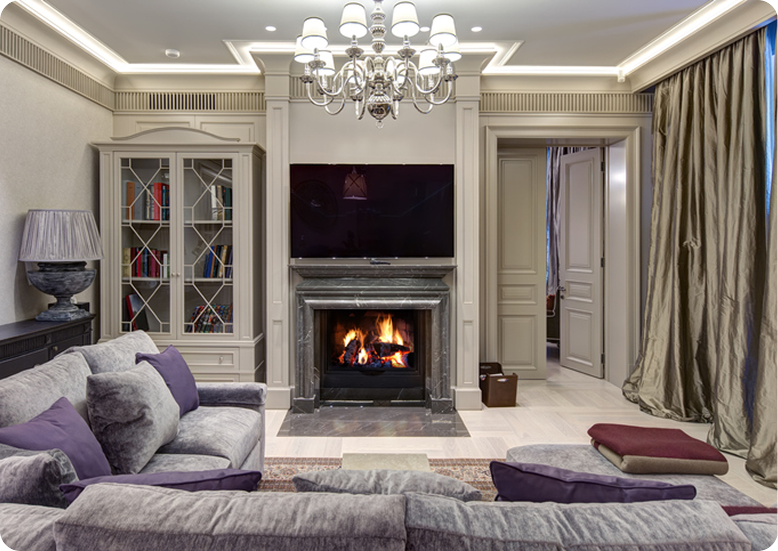 Elegant living room with fireplace and chandelier.