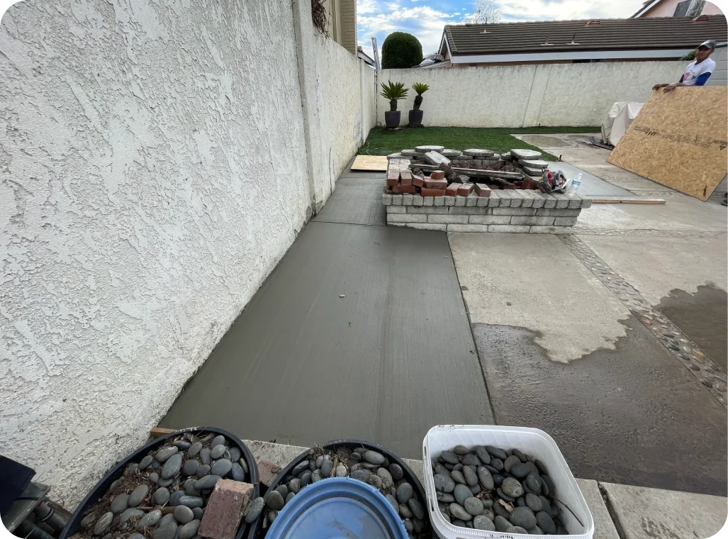 Freshly poured concrete path in backyard.