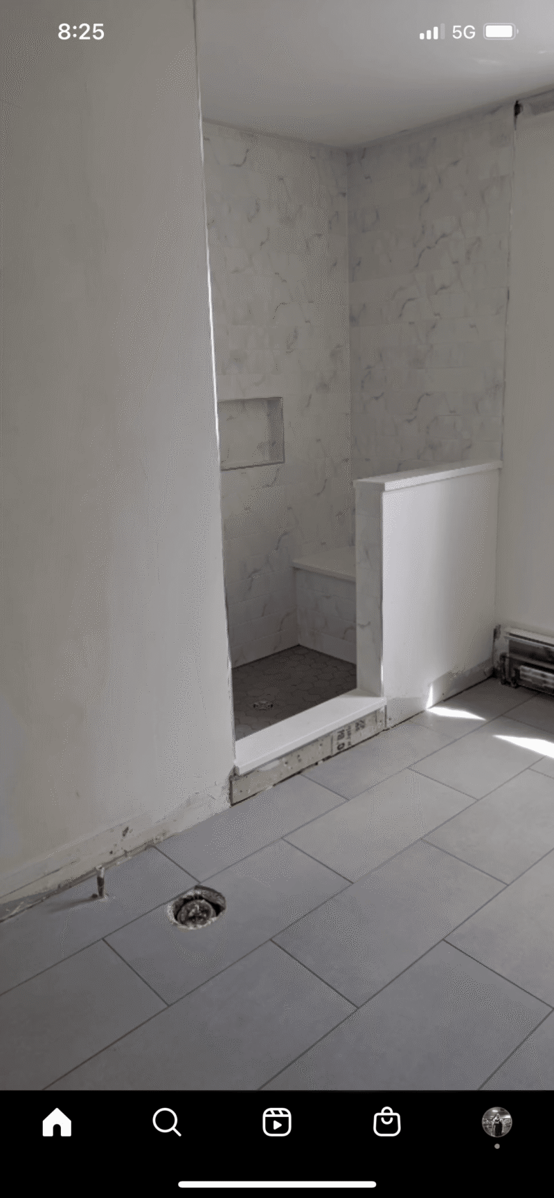 Tiled bathroom renovation with shower niche
